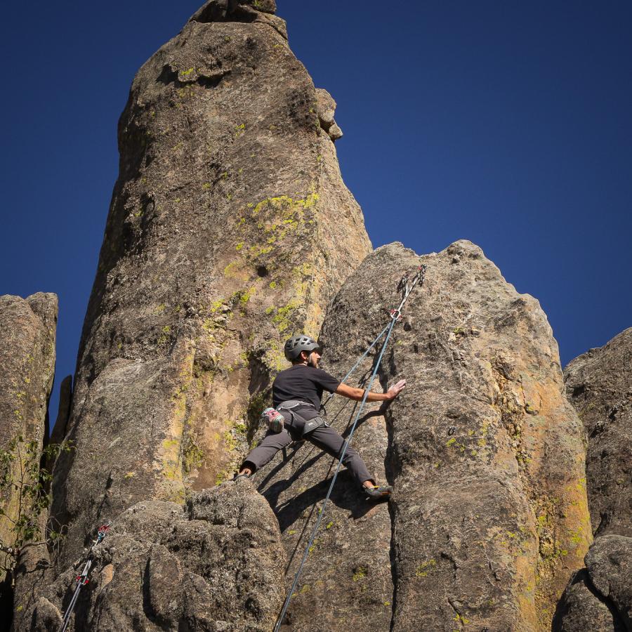 A rock climber sends a 5.10 route at Wrinkled Rock Climbing Area near Keystone, South Dakota 