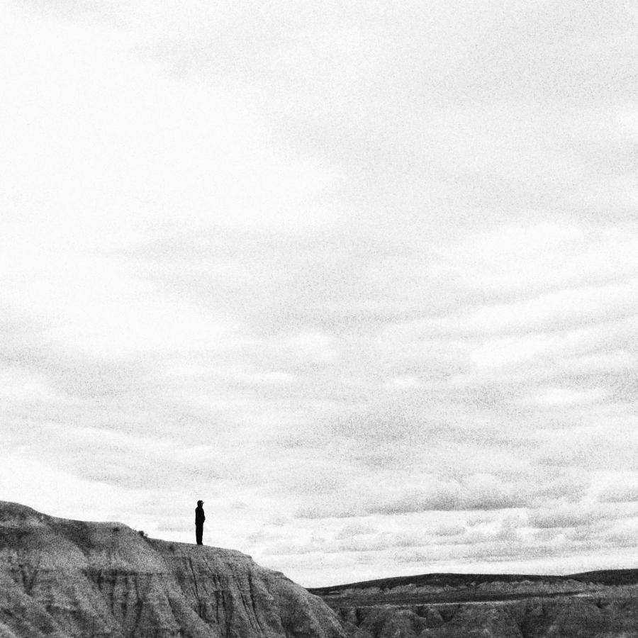 A mere speck of a man, showing reverence to the beauty and scale of the Badlands