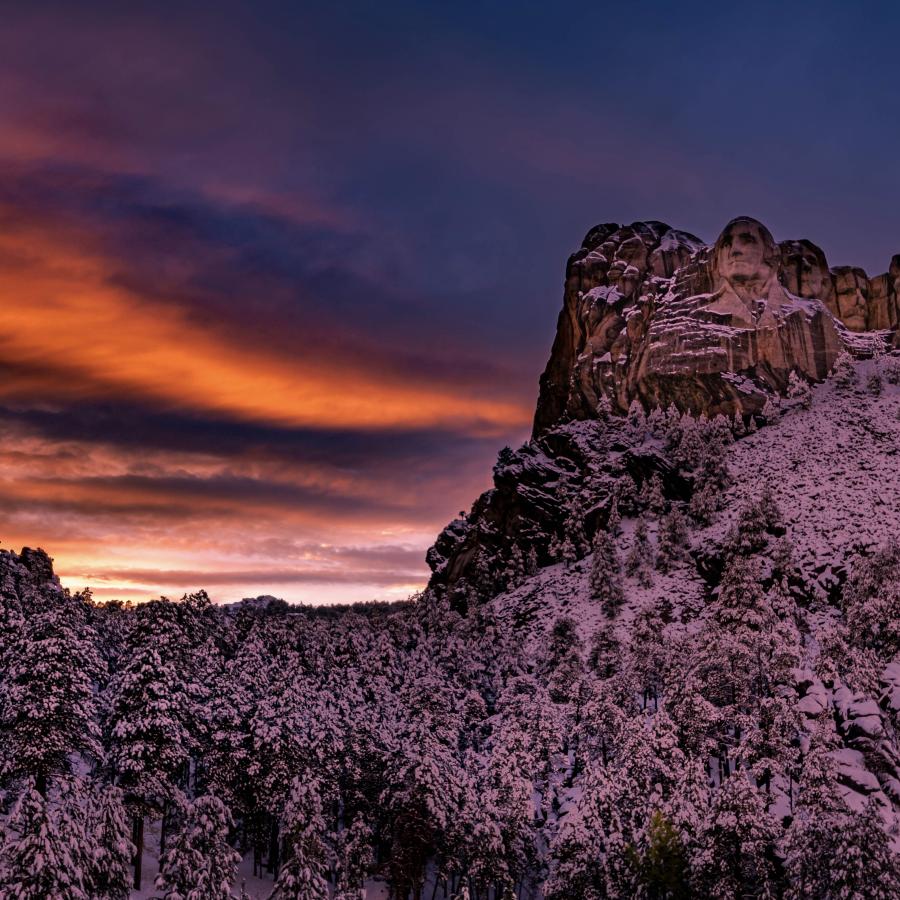 After a early Oct snowstorm that was supposed to be just “flurries”. I braved the brutal windchill to capture the men of all men oversee the the last light of the day.